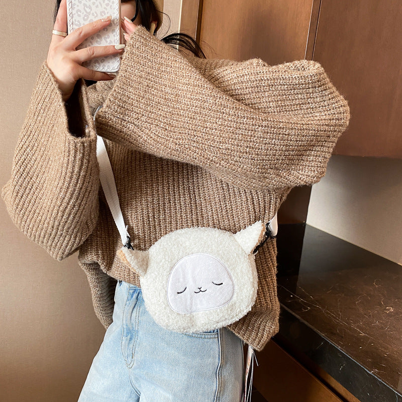 Petit sac rond en peluche mignon et élégant.